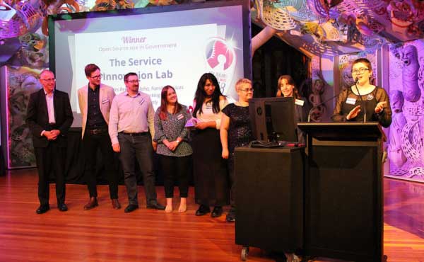 Photo of the team on stage at the awards.